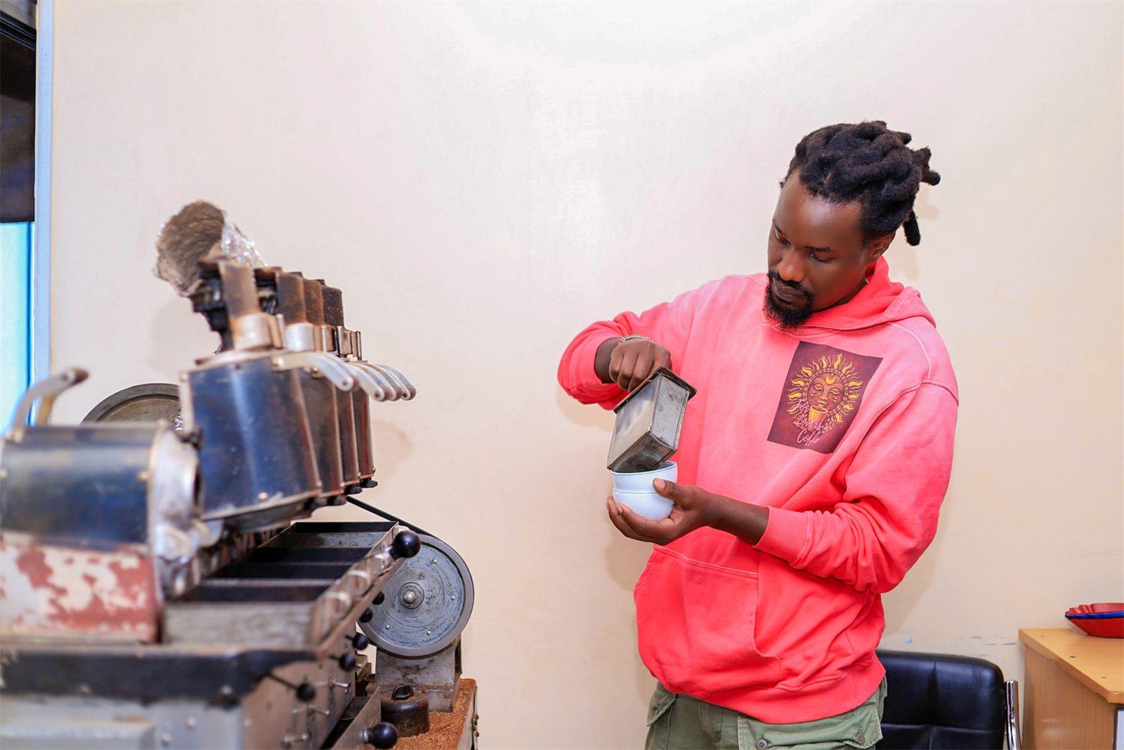 A founder operating a sample roaster in the lab