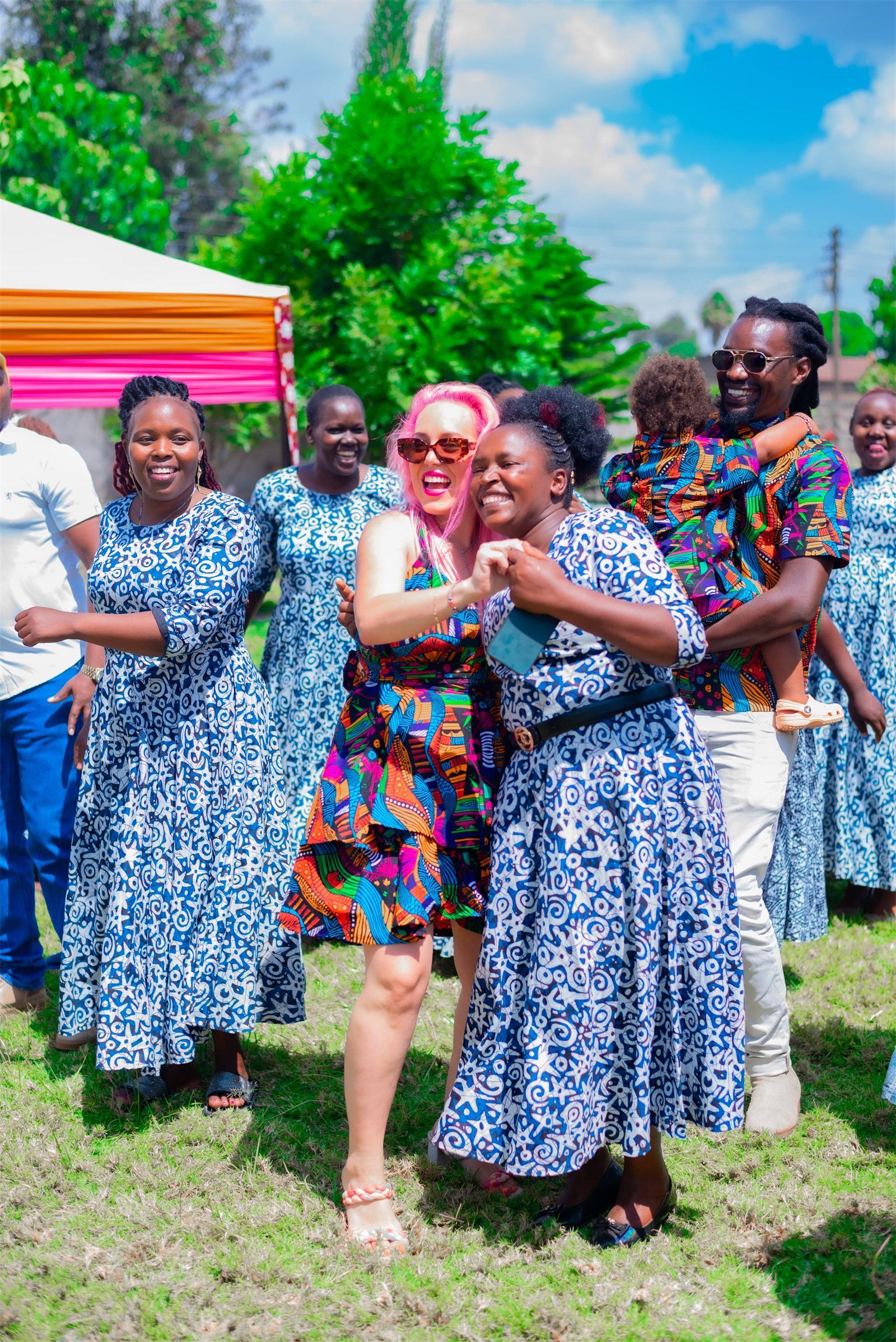 A Mambo Leo founder celebrating with members of a Kenyan women's group in matching dresses
