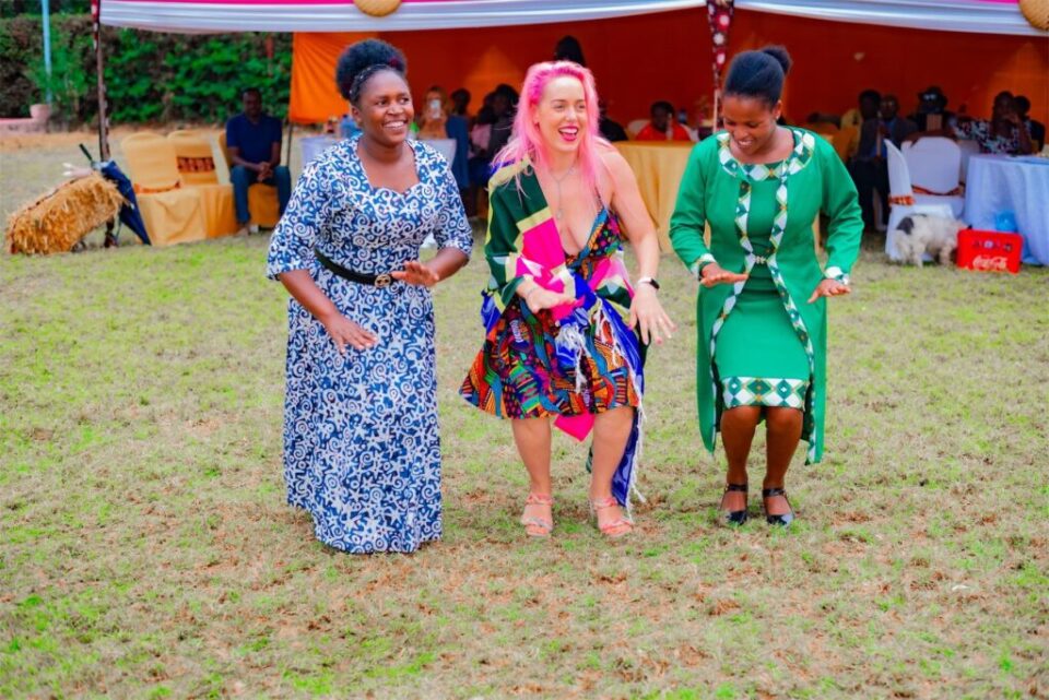 A Mambo Leo founder dancing with members of the Association of Women in Coffee Industry (Kenya)